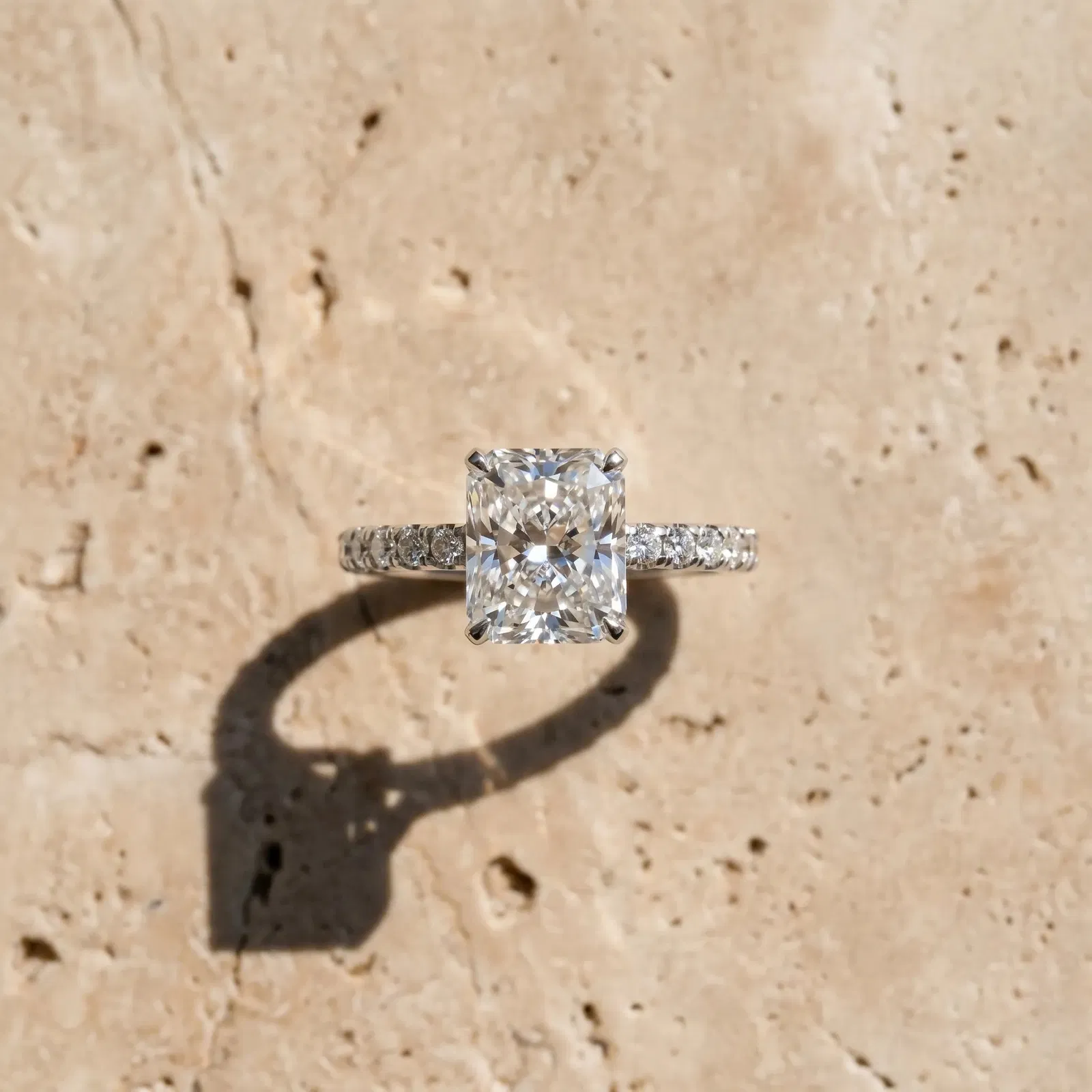 Radiant Cut Diamond Solitaire Ring with Round Pavé Band and Four-Prong Setting Platinum